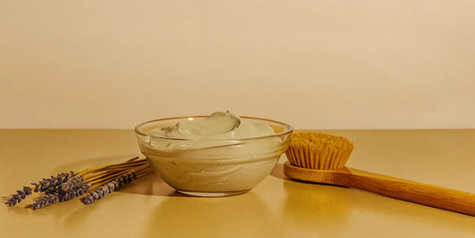 A gentle type of facial for sensitive skin, with a bowl of soothing cream, lavender, and a soft brush.