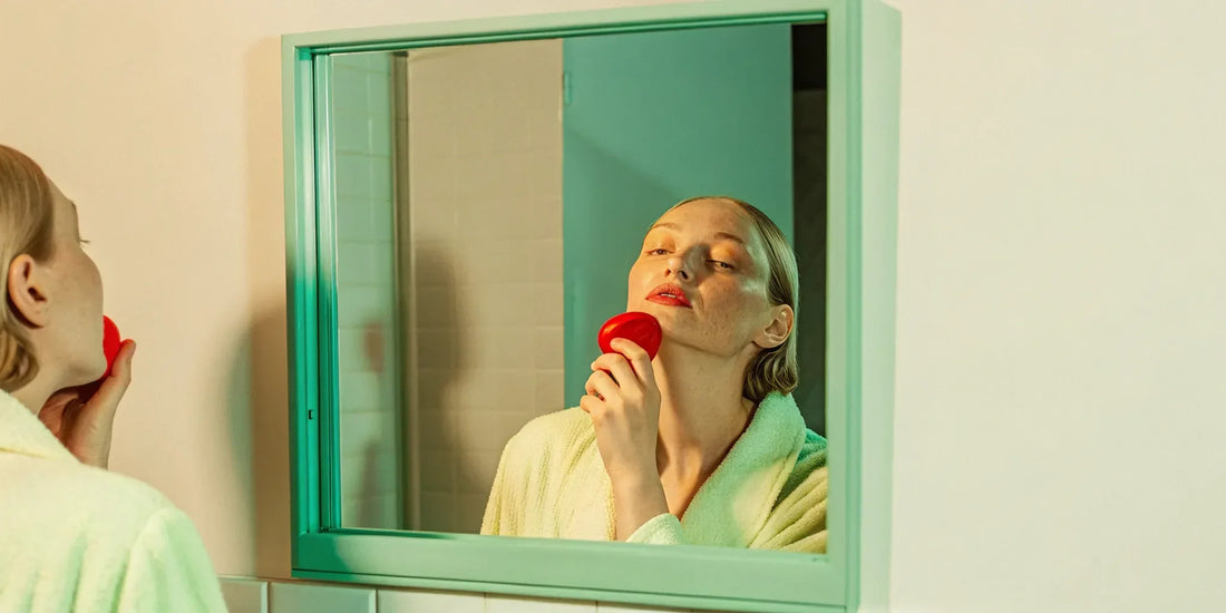 Woman with melasma using red light therapy device.