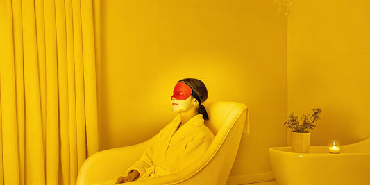 Woman wearing a red light therapy mask, a treatment that has potential side effects.