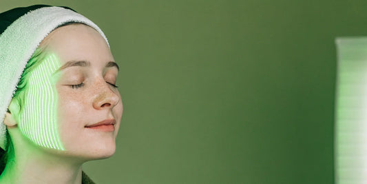 A woman's face under green LED light therapy, a key to great before and after pictures.