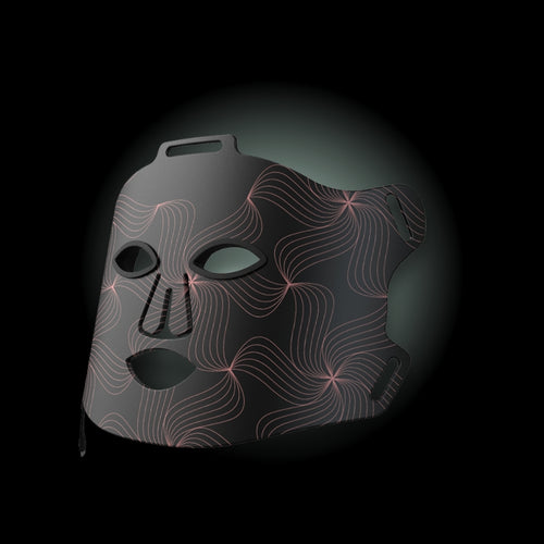 Black mask with wavy line design on a dark background