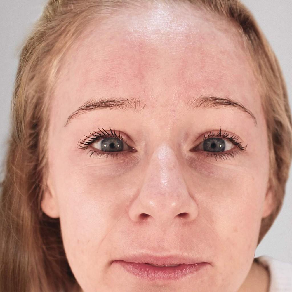 Close-up of a woman's face with a neutral expression.